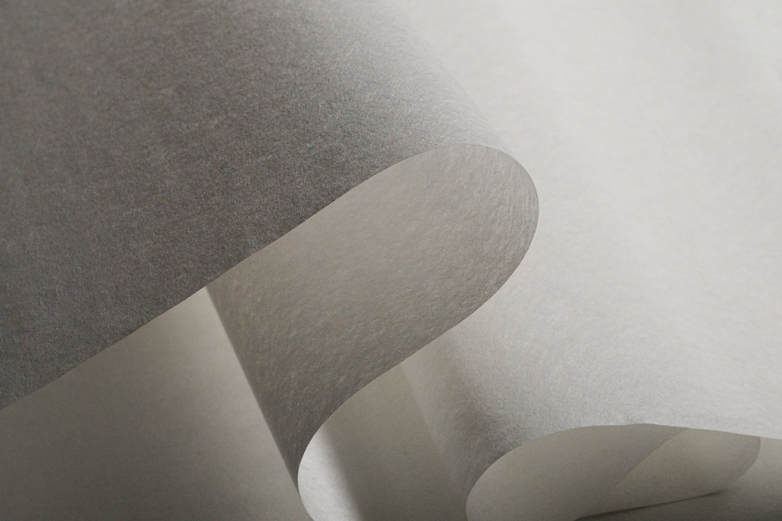 Curled sheets of cuturon and neobond in raking light